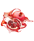 Fresh pomegranate fruit with juicy seeds and splashes of pomegranate juice.